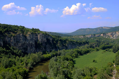 Idyllic shot of green landscape against sky