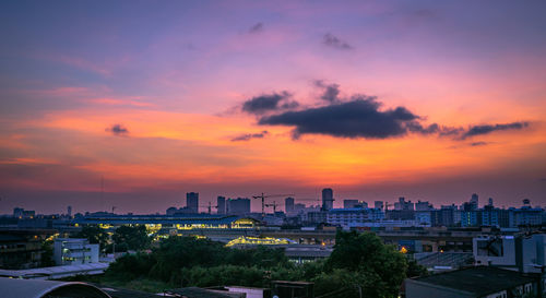 High angle view of buildings against cloudy sky during sunset