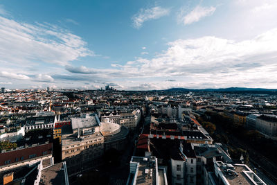 High angle view of cityscape against cloudy sky