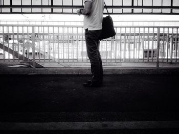 Full length of woman standing by railing