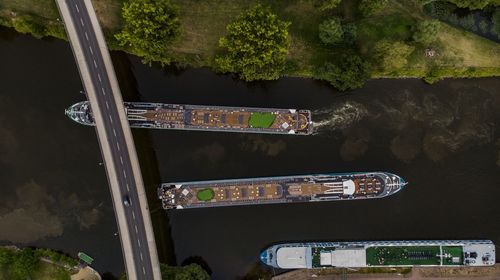 High angle view of road by trees in city