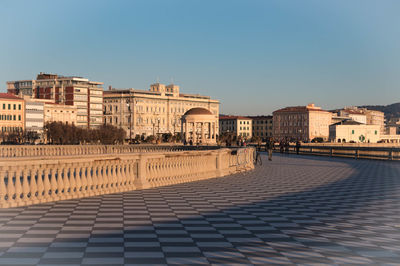 View of buildings in town against clear sky