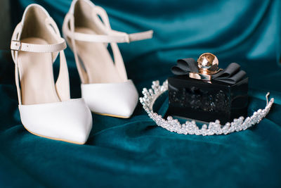 Bridal accessories. bridal shoes, perfume and crown.