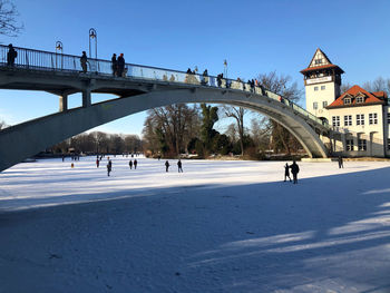 People walking on bridge in winter