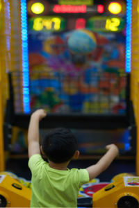 Rear view of boy playing