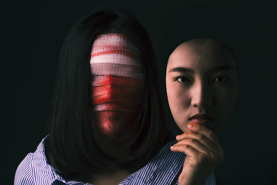 Close-up of woman with bandages on face representing plastic surgery