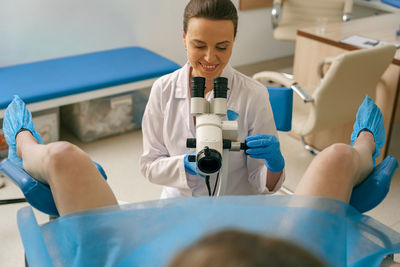 Rear view of woman exercising in hospital