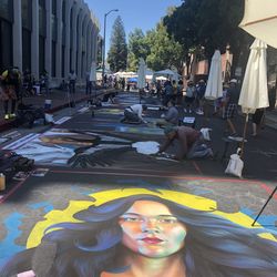 People on street against buildings in city