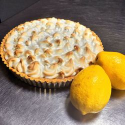 High angle view of sweet food by lemons on table