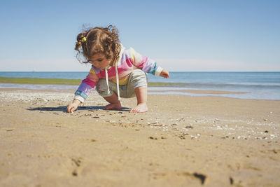 Side view of boy playing at beach