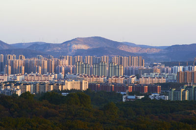 View of cityscape against mountain range