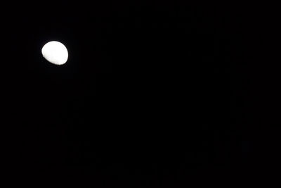 Low angle view of moon against clear sky at night