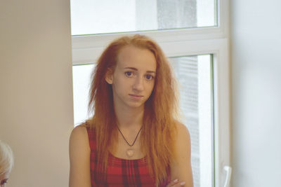 Portrait of young woman with redhead