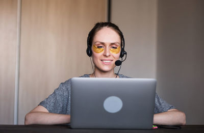 Businesswoman working on laptop at home