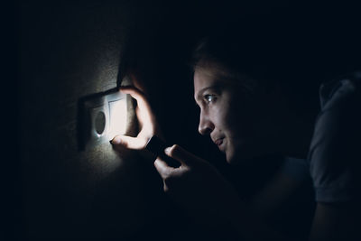 Close-up of young woman looking through window