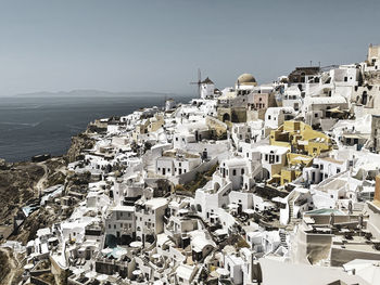 High angle view of townscape by sea against sky