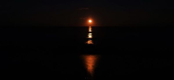 Scenic view of sea against sky at night