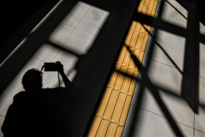Shadow of person on tiled floor