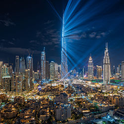 Illuminated cityscape against sky at night