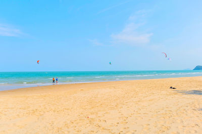 Scenic view of beach against blue sky