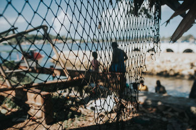 Close-up of chainlink fence against sky