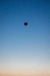 Low angle view of hot air balloon against clear blue sky