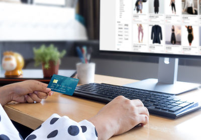 Close-up of person using laptop on table