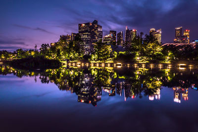 Reflection of illuminated buildings in lake at night