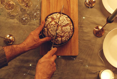 Cropped hands of person preparing food on table