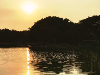 Scenic view of lake against sky during sunset