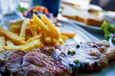 Close-up of fries and vegetables in plate