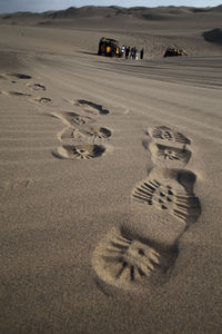 High angle view of footprints on sand at beach