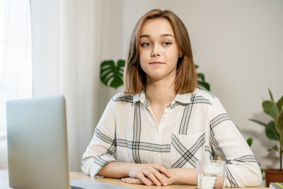  female freelancer working at home office. girl using a computer for study online at home. 