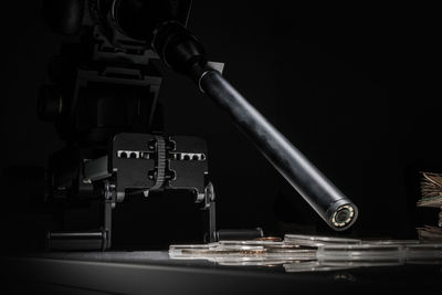 Close-up of machinery on table against black background