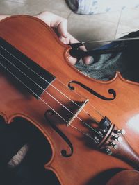 High angle view of hands playing piano