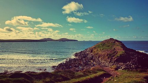 Scenic view of sea against cloudy sky