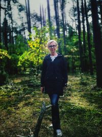 Portrait of man standing in forest