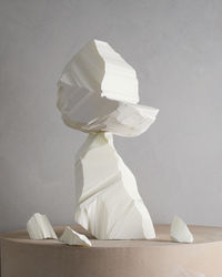 Close-up of white chalk stack on table against wall at home