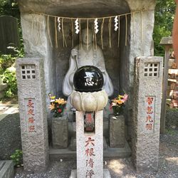 Statue by flowers