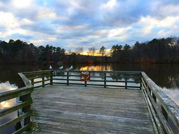 View of calm lake against cloudy sky