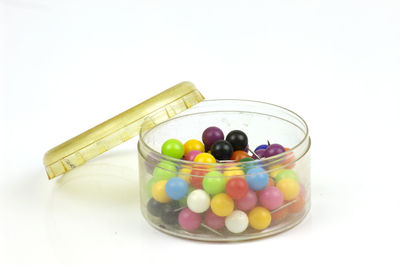 High angle view of multi colored glass on white background