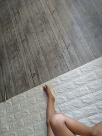 Low section of woman lying on floor