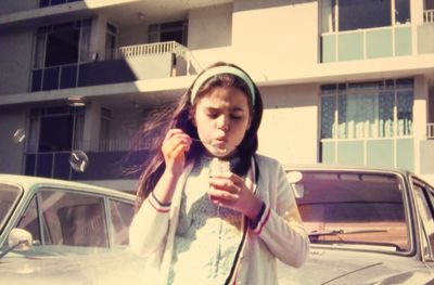 Beautiful young woman in front of building