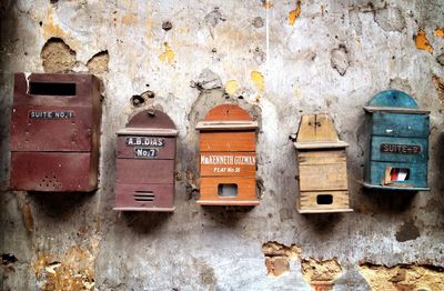 Old mailboxes at weathered wall
