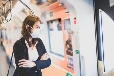 Full length of woman standing by train