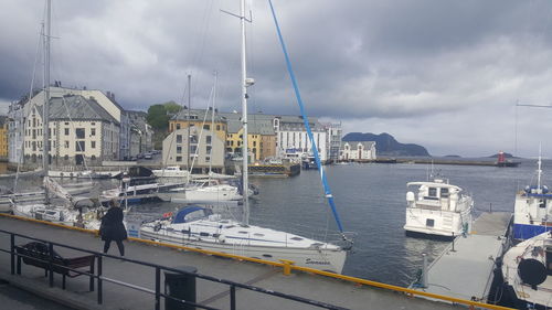 View of harbor against cloudy sky