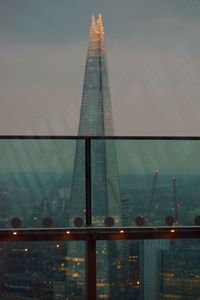 View of modern building against cloudy sky