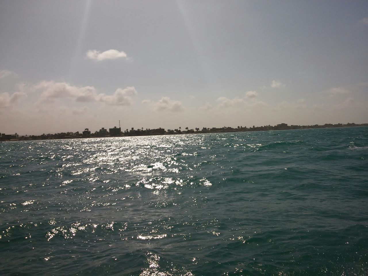 water, sea, sky, tranquil scene, scenics, waterfront, tranquility, beauty in nature, rippled, nature, sunlight, cloud - sky, horizon over water, idyllic, outdoors, blue, cloud, reflection, day, no people