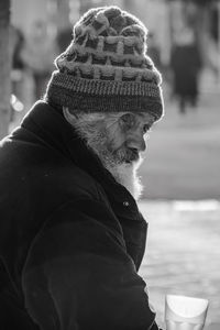 Side view of man wearing hat during winter