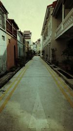 Empty road with buildings in background